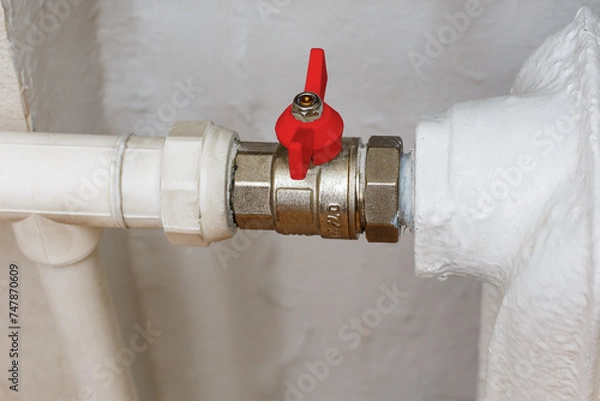 Fototapeta Ball valve with red handle when closed. Shut-off valves for the heating system of the apartment. Turn off the faucet.