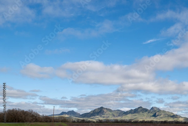 Obraz The Sutter Buttes, known as the Smallest Mountain Range, on a partly cloudy day and blue sky copy-space