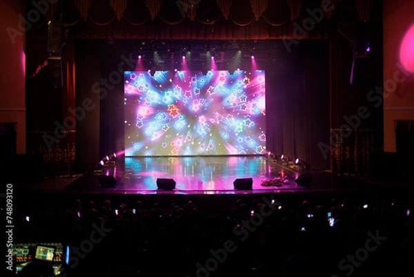 Fototapeta An empty stage of the theater, lit by spotlights and smoke before the performance