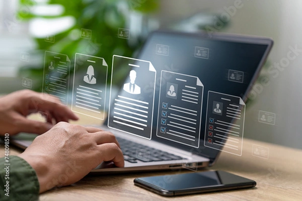 Obraz HR Management document online checklist, Human Resources concept, Businessman search best Human Resources from online application and qualifications employees select the best people to join the team