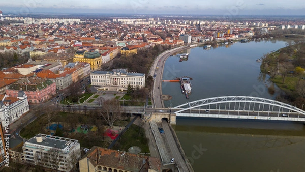 Fototapeta Drone footage from downtown of Szeged, Hungary on a sunny winter day.
Szeged, Drone, Aerial, Hungary, Urban Landscape, Szeged Cathedral, Tisza River, Bridge
