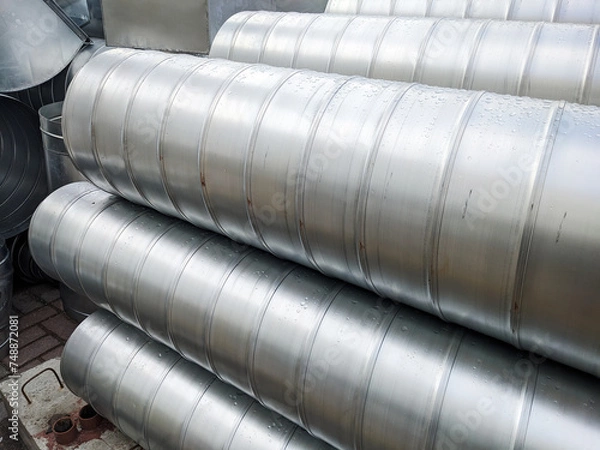 Fototapeta Piles of metallic pipes neatly stacked in a warehouse. Infrastructure Details