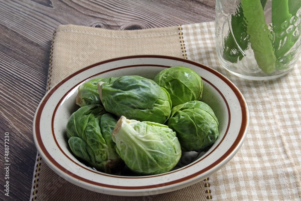 Obraz Fresh Brussels sprouts in a bowl, ready to cook.