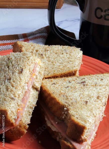 Obraz Closeup of a cold meat sandwich on multigrain bread with coffee.