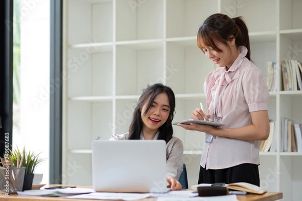 Obraz Two business people talk project strategy at office Businessman discuss project planning with colleague at modern workplace while having conversation and advice on financial data report