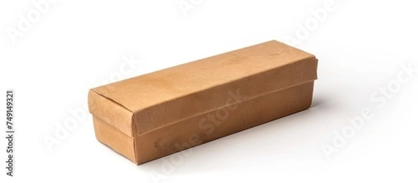 Fototapeta A brown cardboard box is placed on top of a clean white surface. The box appears to be sturdy and durable, with visible creases and flaps. It sits upright, casting a slight shadow underneath.