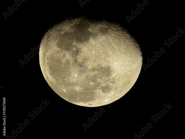 Fototapeta a full moon with a black background in the night sky