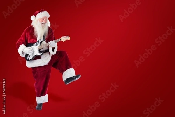 Obraz Composite image of santa claus has fun with a guitar