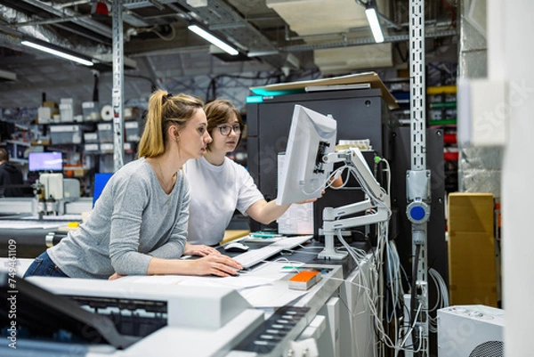 Obraz Professional female employees working in a printing house