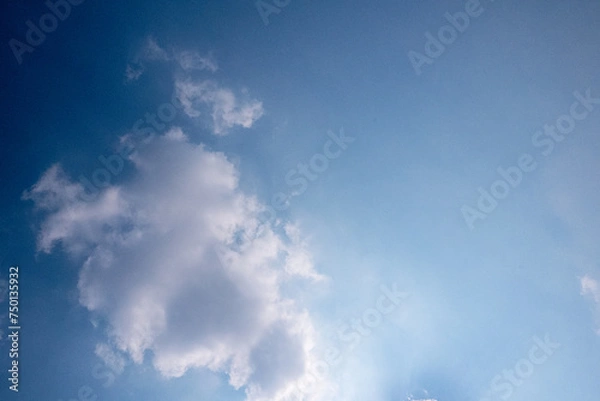 Obraz blue sky with white clouds sunray background