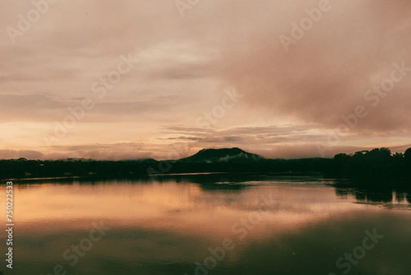 Fototapeta Sunset over the Vaupes River in the Amazon jungle next to a hill.