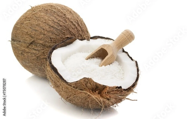 Fototapeta A coconut with desiccated coconut and scoop on white background