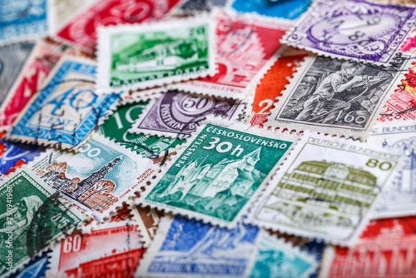 Fototapeta Postage stamps.A collection of world stamps in a pile.Postage stamps from different countries and times