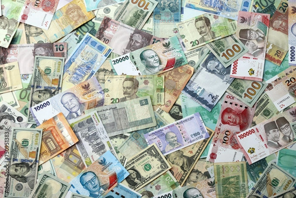 Obraz Many banknotes of different currency. Background of big amount of random money bills close up