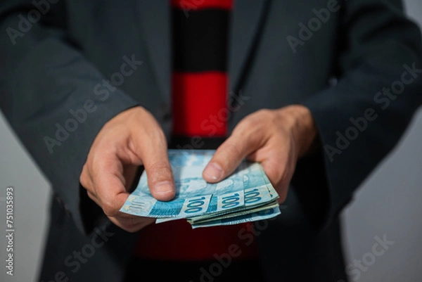 Fototapeta The picture represents cases of corruption and bribery in many different cases such as politics, football, business in Brazil, Europe and the USA. This could be in dollar, euro or brazilian real.