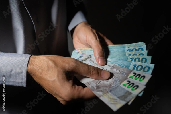 Fototapeta The picture represents cases of corruption and bribery in many different cases such as politics, football, business in Brazil, Europe and the USA. This could be in dollar, euro or brazilian real.