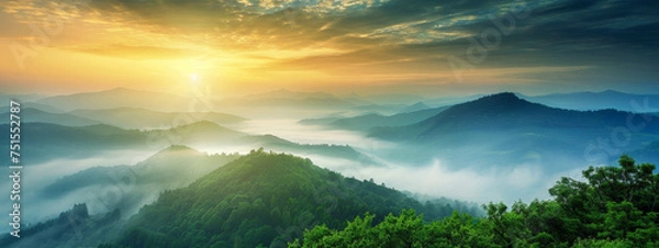 Obraz A beautiful mountain range with a sun setting in the background