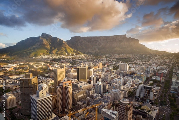 Fototapeta An aerial view of Cape Town central business district in late afternoon as the sun is setting, showing Table Mountain.