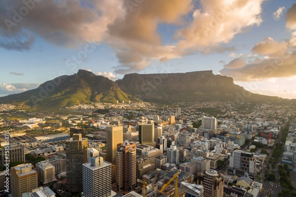 Fototapeta An aerial view of Cape Town central business district in late afternoon as the sun is setting, showing Table Mountain.