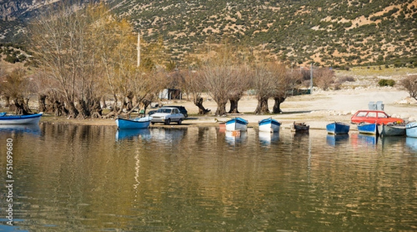 Fototapeta Decorated day-trip boats in Isikli Lake in Denizli's Civril district. Isıkli Lake is flooded with visitors during lotus time. It is also a popular lake for hunters.