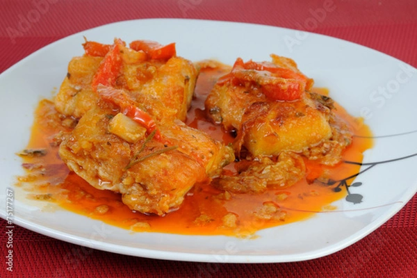 Obraz Fish dish with onions and peppers sauce