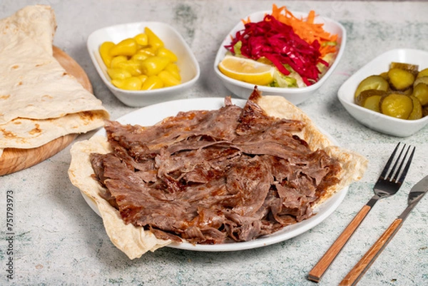 Fototapeta Meat doner kebab. Turkish and Middle Eastern cuisine flavors. Doner kebab on stone floor. Local name tabakta et döner