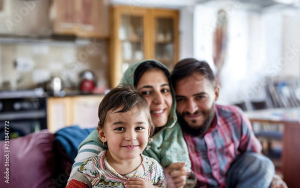 Fototapeta Candid moment of a Syrian immigrant family at home, with father, mother, and children sharing laughter in a warm, familial setting.

