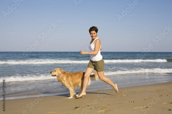 Fototapeta Young girl and dog playing