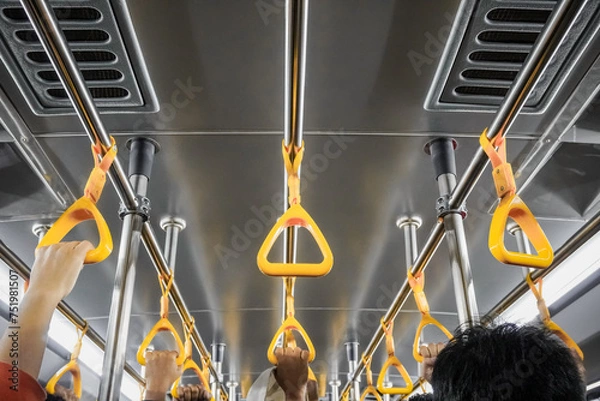 Fototapeta Passengers on public transportation gripping handrail