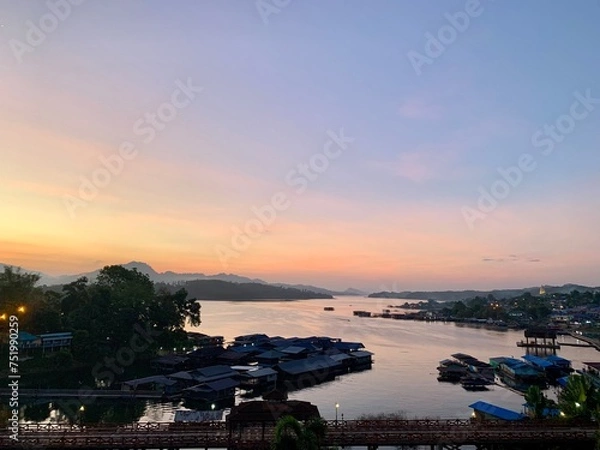 Fototapeta The bridge is embraced by verdant mountain ranges, surrounded by plants of diverse species, and covered by a thin layer of fog. The dazzling bridge that reflects the charm of local people's way of lif