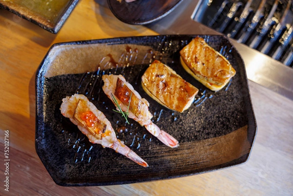 Fototapeta Sushi nigiri shrimp burned and topped with Shrimp Eggs and foie gras
