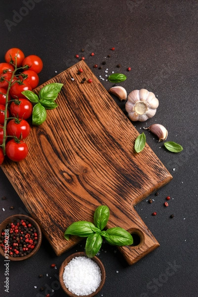 Fototapeta Food background with space for text. Wooden board with vegetables and spices