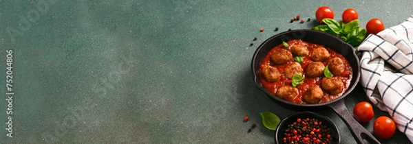 Fototapeta .Meatballs with tomato sauce and basil in a frying pan