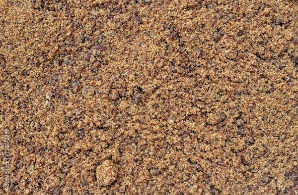 Fototapeta Granulated Sugarcane Jaggery or Indian Gur Background with Copy Space in Horizontal Orientation