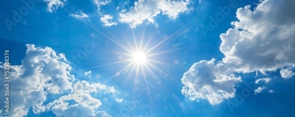 Fototapeta View of the sun in the blue sky with clouds.