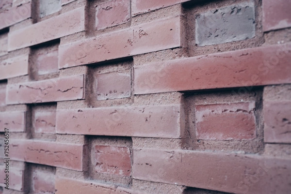 Fototapeta Backsteinmauer mit strukturierter Formation.