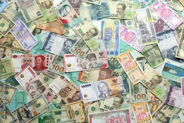 Obraz Many banknotes of different currency. Background of big amount of random money bills close up
