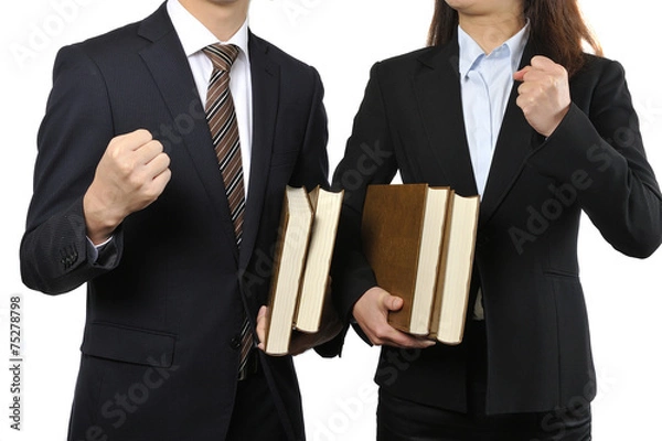 Obraz 難しい本を読んで調べている男女の二人のビジネスマン