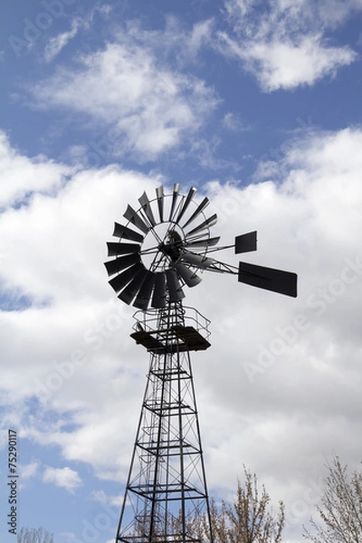 Obraz Windmill against blue cloudy sky
