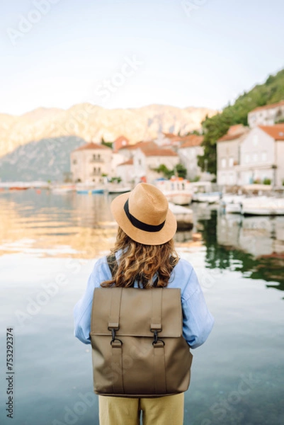 Fototapeta A woman tourist walks and enjoys the views and attractions. Travelling, lifestyle, adventure.
