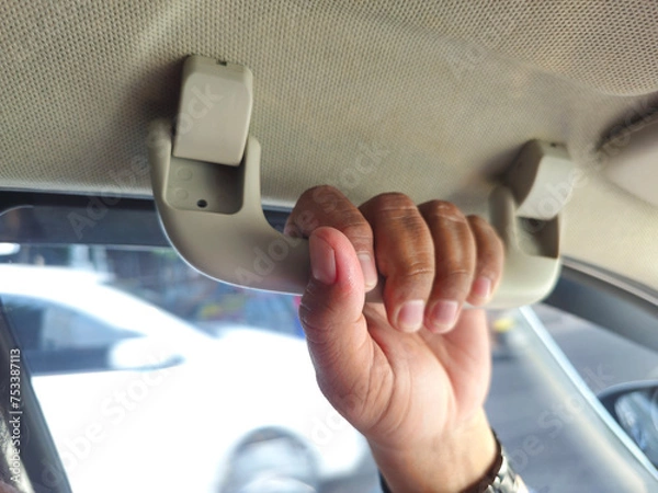 Obraz close up of hand hold on roof car hand grip