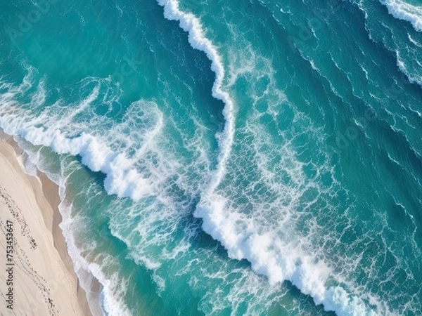 Fototapeta Take a picture of the beach and waves from above using the drone's top-down, blue ocean view.