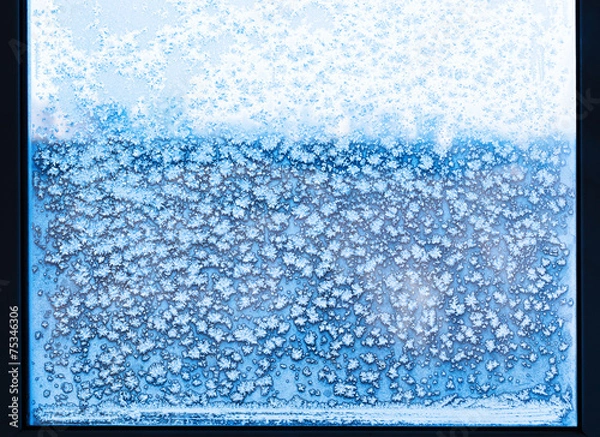 Fototapeta snowflakes and frost pattern on frozen window