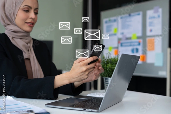 Fototapeta muslim business woman wearing hijab checking working schedule plan at her working desk.