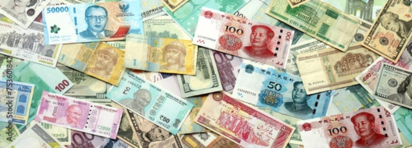 Obraz Many banknotes of different currency. Background of big amount of random money bills close up