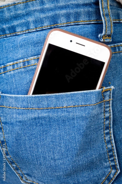 Obraz Cell phone in back pocket of girl's jeans