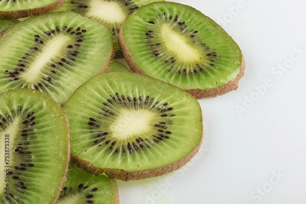 Fototapeta Juicy ripe sliced kiwi fruit isolated on white background. Copy space.