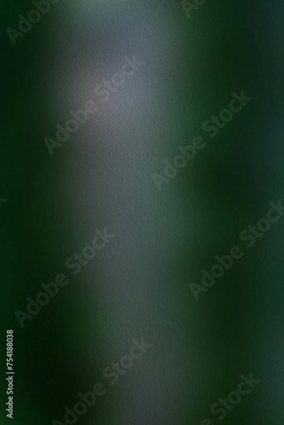Fototapeta A blurr texture background of dark green to lighter green hues, giving it a mysterious and enigmatic aura