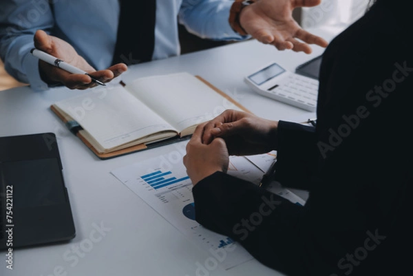 Fototapeta Business team working with new startup project plan and discussion information for financial strategy with laptop and digital tablet in a modern business lounge.