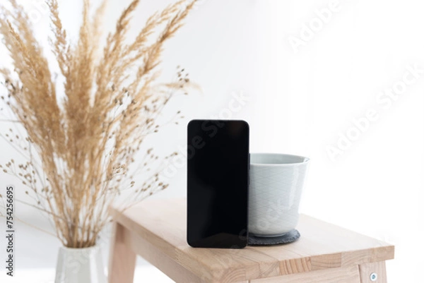 Obraz Coffemug with smartphone and dryflowers